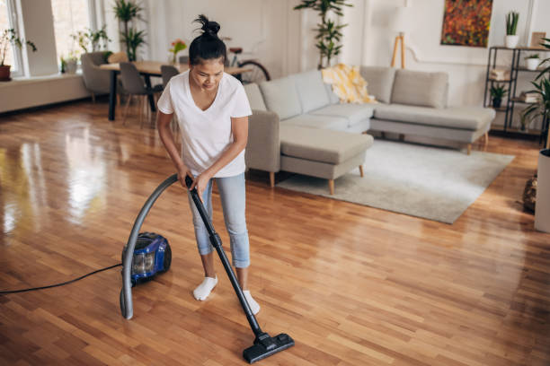 istock Woman vacuuming at home 1329857353
