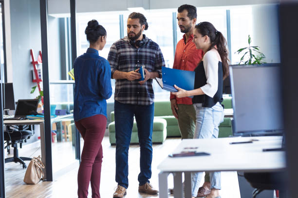 istock Diverse group of creative colleagues talking at casual meeting 1329857898