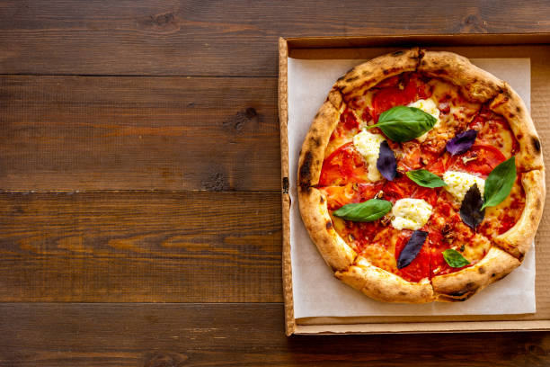 Delicious pizza with cheese tomatoes sauce and basil