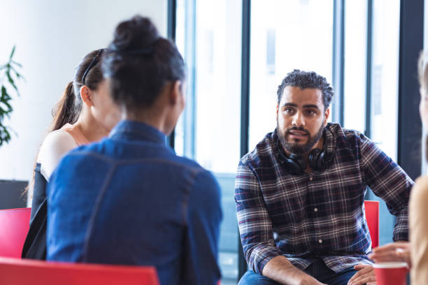 istock Diverse group of creative colleagues talking at casual meeting 1329858376