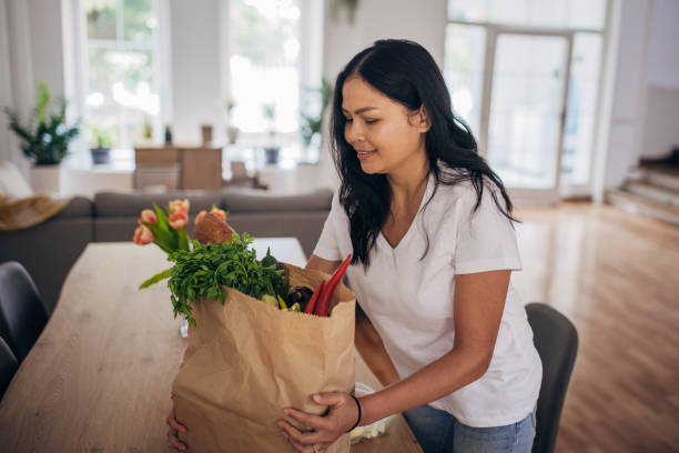 istock Woman back from groceries shopping 1329859629