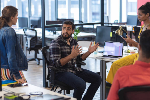 istock Diverse group of creative colleagues talking at casual meeting 1329859755