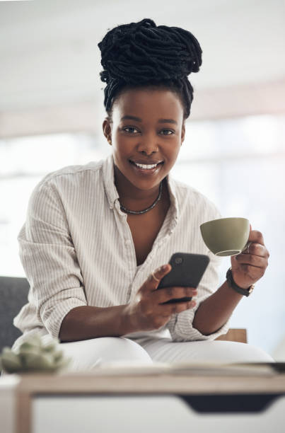 istock Shot of a businesswoman using her smartphone to send text messages while drinking coffee 1329860664