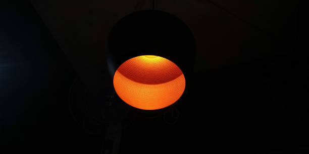 istock Black Chinese Lamp emitting orange light hanging from roof 1329862221