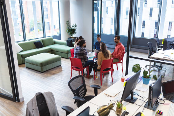 istock Diverse group of creative colleagues talking at casual meeting 1329862397