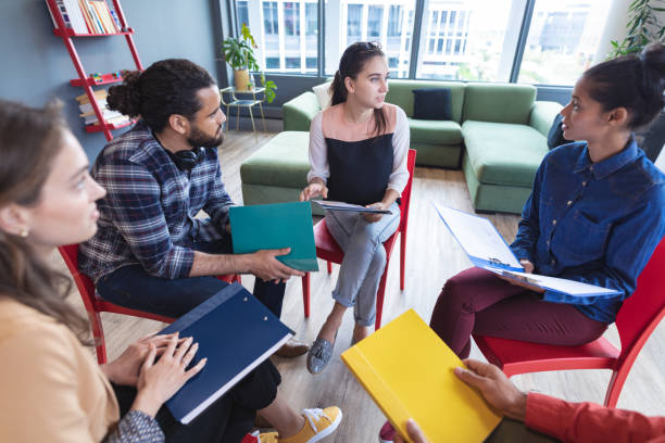 istock Diverse group of creative colleagues talking at casual meeting 1329862398