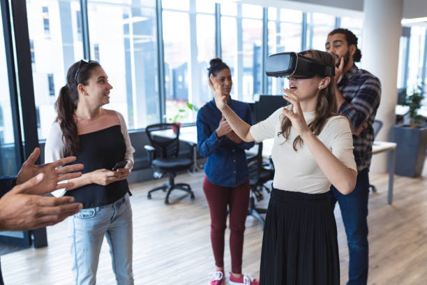 istock Diverse group of creative colleagues talking at meeting using vr headset 1329862778