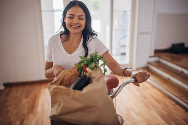 istock Woman back home from groceries shopping 1329864122