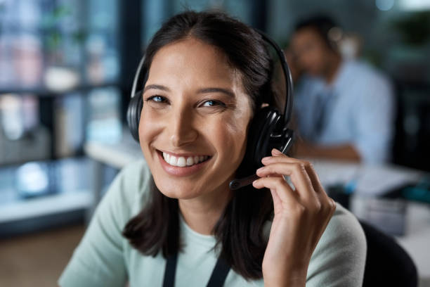 istock Portrait of a young woman using a headset in a modern office 1329866257