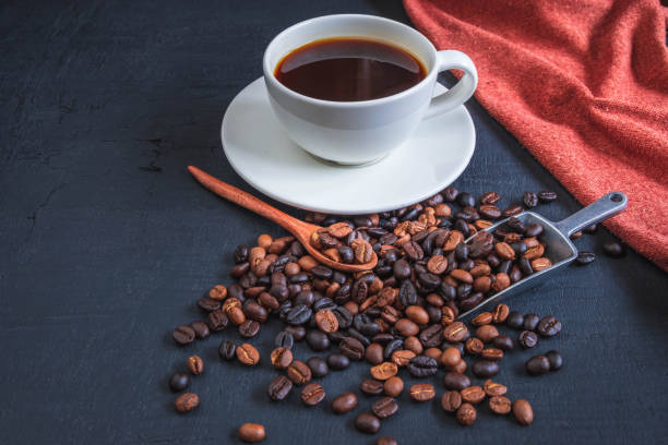 istock cup of coffee and coffee beans on black background 1329866894