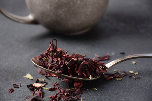 istock Dry Hibiscus tea in a spoon. Tea concept 1329867171