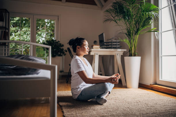 istock Woman meditating in bedroom 1329867211