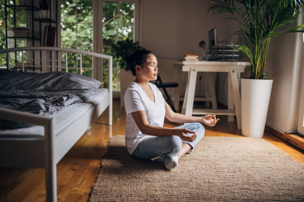 istock Woman meditating in bedroom 1329867241