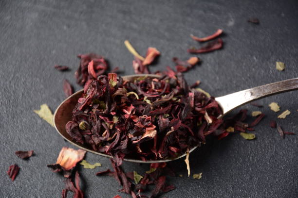 istock Dry Hibiscus tea in a spoon. Tea concept 1329867318