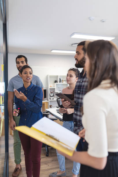 istock Diverse group of creative colleagues discussing work and brainstorming at meeting 1329868408
