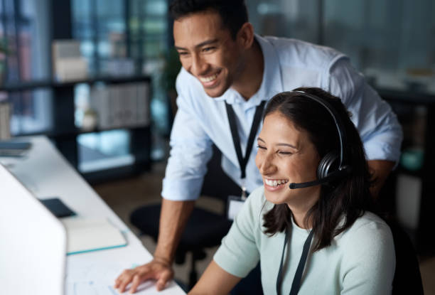 istock Shot of a young man and woman using a computer while working in a call centre. 1329870139