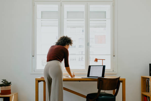 istock Anonymous Afro Female Entrepreneur Analyzing Data in her Home Office 1329870955