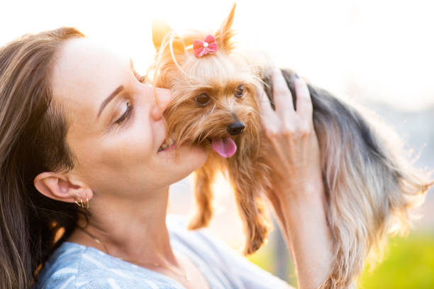 istock woman playing with the dog 1329871592