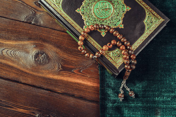 istock islamic holy book on wooden table 1329873486