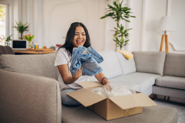 istock Woman opening a package at home 1329874654