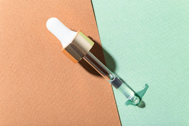 Skin Care oil essence serum and liquid Collagen with pipettes on a brown and green background. Skin Care oil essence serum and liquid Collagen with pipettes on a brown and green background. serum sample stock pictures, royalty-free photos & images