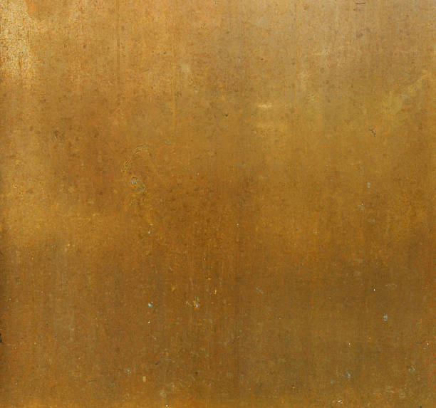 istock ancient golden metal surface with orange and yellow tones - worn background 1329874991