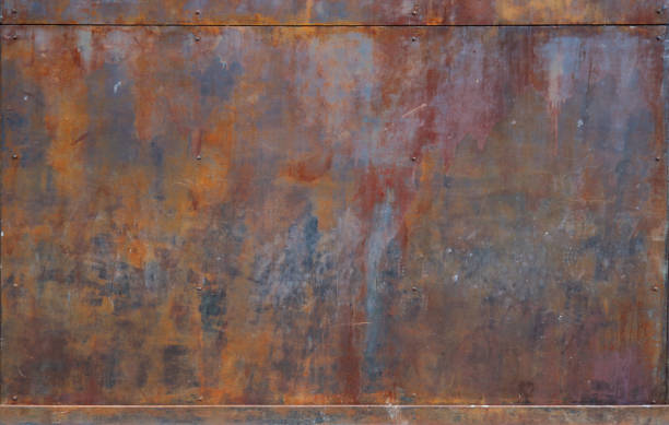 istock rusty metal surface with red, black and orange tones, framed up and down - worn irregular steampunk background with scratches 1329874995