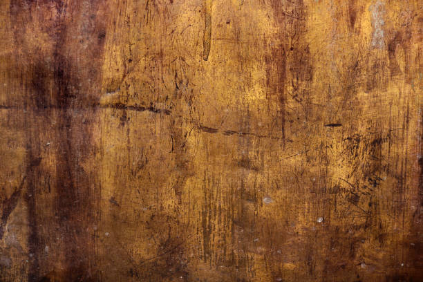 istock golden metal rough surface with irregular yellow and dark brown tones - worn steampunk background with dirty texture and scratches for an epic wallpaper of a goldmine 1329875079