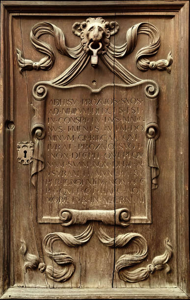 istock vertical ancient bas relief carved in wood which represents a lion holding a parchment with text and ornaments, all framed in a wooden door 1329876319
