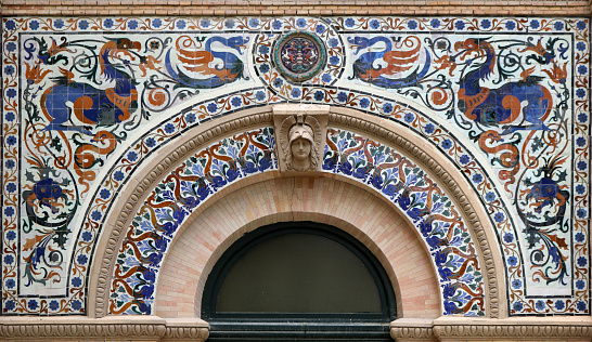 Ornate classic style arch with colorful decorative motifs - This decoration belongs to the Palace of Velazquez, built in 1881, and is located in Retiro Park of Madrid