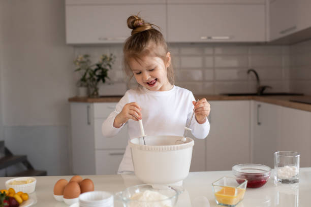 istock Cute kid girl cook at home kitchen 1329876397
