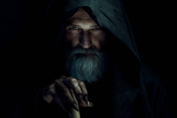 Wizard Portrait of senior mysterious wizard wearing hooded dress wizard stock pictures, royalty-free photos & images
