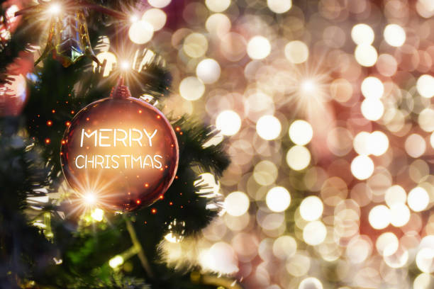 istock Merry christmas word on red ball decoration on christmas tree on abstract bokeh blurred background 1329877848