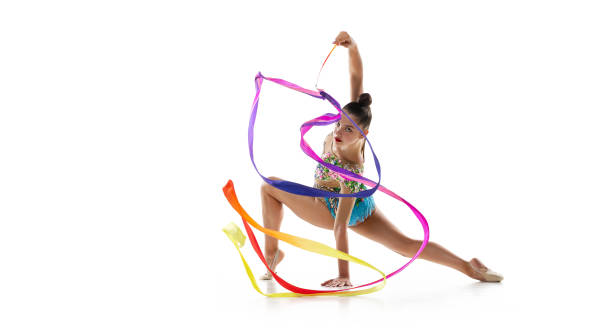 istock One young female rhythmic gymnast practicing with colored ribbon isolated over white studio background. 1329878437