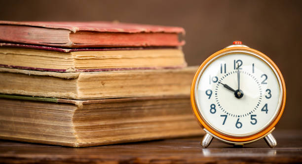 istock Retro clock and books, back to school , education, learning history banner 1329878602