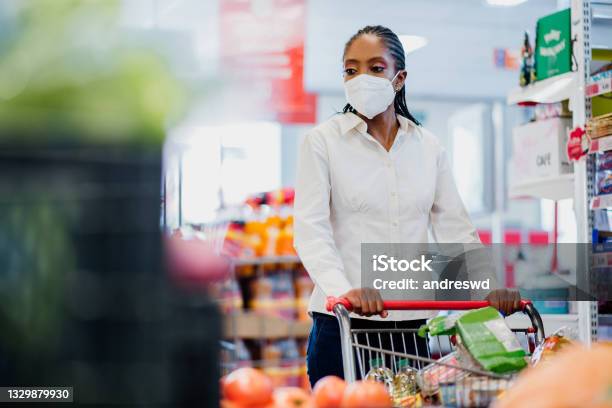 Woman Shopping In Supermarket Wearing Coronavirus Face Mask Stock Photo - Download Image Now