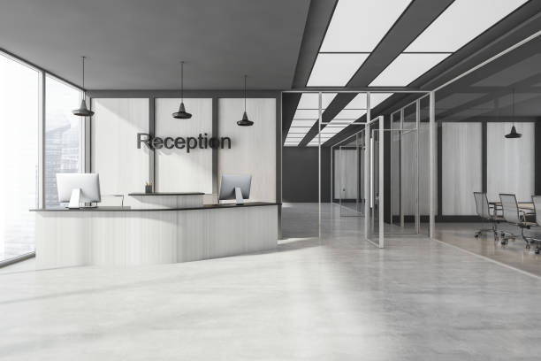 istock Grey reception interior with desk and computers near window, hall with rooms 1329880124