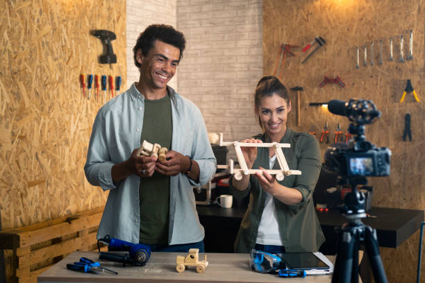 istock Two people in a carpentry workshop being filmed with a camera for a blog 1329880815