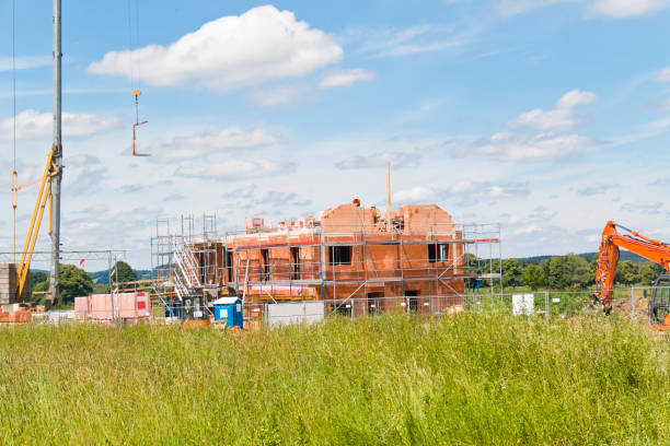 Construction site of an apartment building in the middle of the countryside.