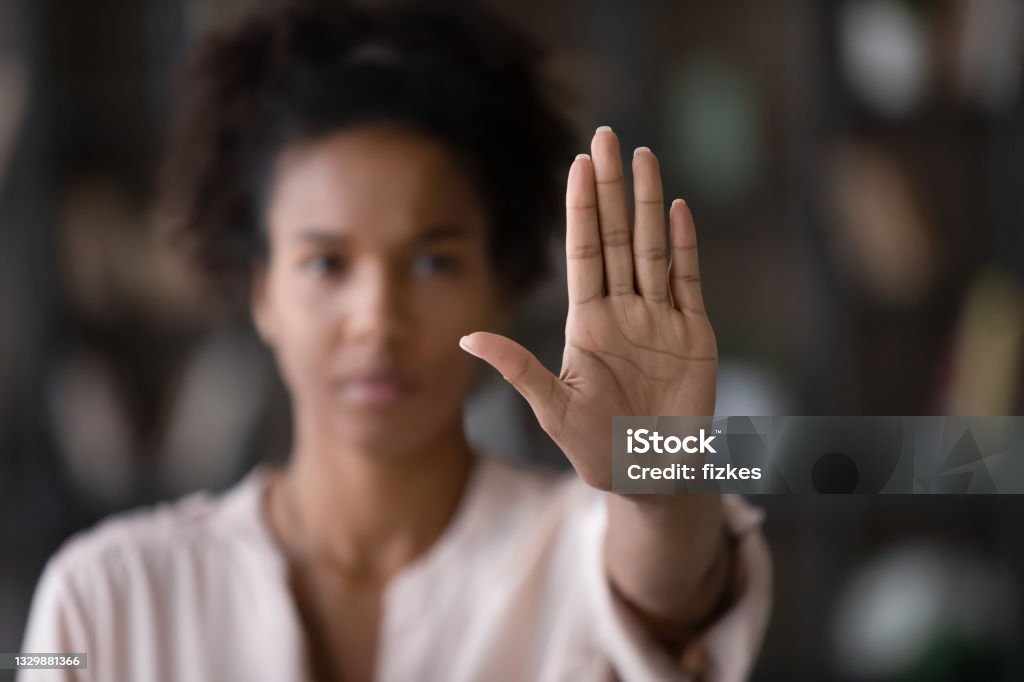 Close up African American woman showing stop gesture with hand Close up of African American woman showing stop gesture with hand blurred background, young female protesting against domestic violence and abuse, bullying, saying no to gender discrimination Prejudice Stock Photo