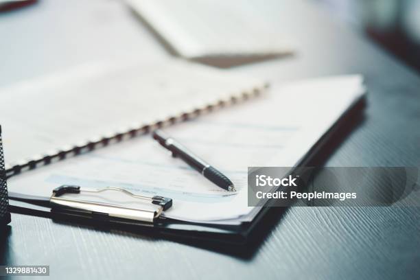 Shot Of A Notebook And Pen On A Desk In An Office Stock Photo - Download Image Now - Document, Paperwork, Insurance