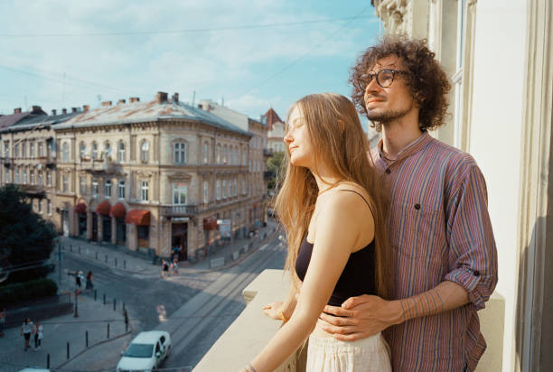 istock Couple  standing on balcony. Camera film 1329882254