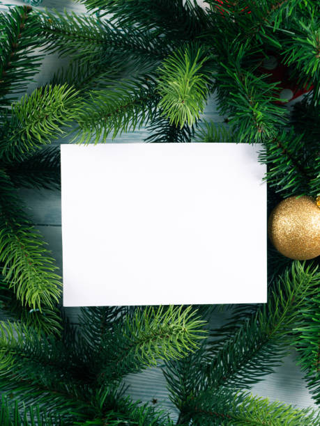 istock Christmas new year background with white empty card for text in green fir tree branches frame 1329883508