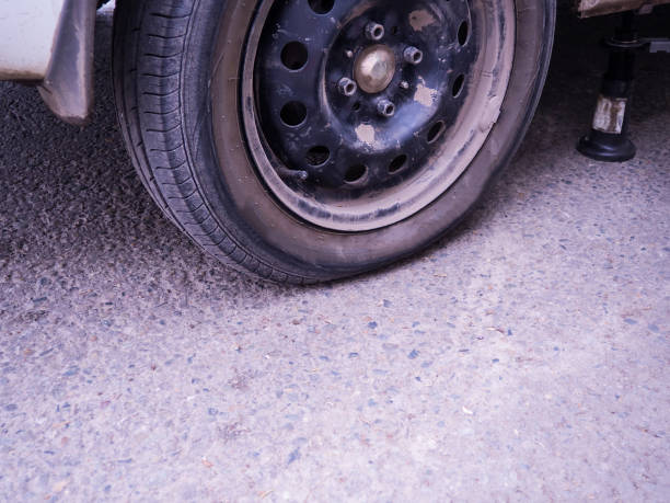 istock Close-up flat car tire, punctured wheel. 1329883689
