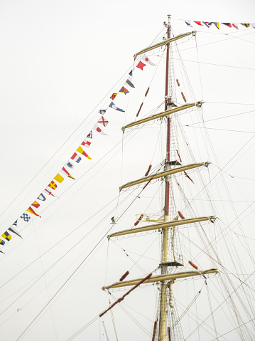 Close up of the rigging and signal flags of a full rigged ship during the Tall ship Festival, Greenwich, UK. Photo was taken during the tall ship festival of 2014