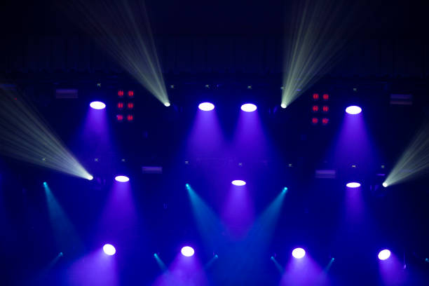 istock Blue background with stage light white and pink beams. 1329883876