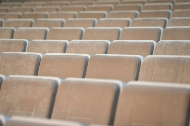istock A row of empty beige chairs in the auditorium. 1329885045