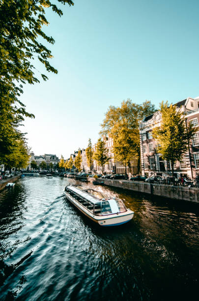 istock Boat Sailing On Beautiful Amsterdam Canal, The Netherlands 1329886418