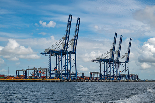 Charleston, SC, USA - July 17, 2021: Ship-to-shore cranes capable of working the largest cargo ships calling on the east coast of the United States sit at Hugh K. Leatherman terminal, which opened in 2021 on the Cooper River in Charleston Harbor.