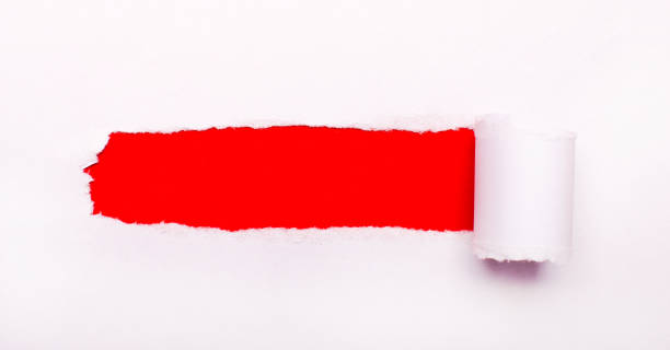 istock On a bright red background, white paper with a torn strip and a place to insert text. Template 1329887656